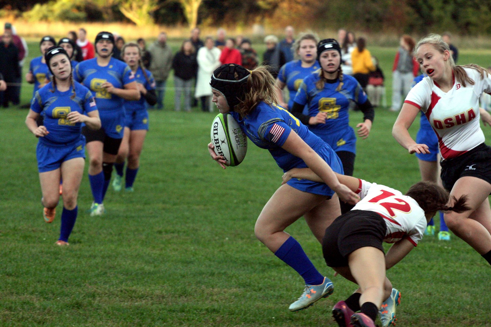 CMH girls rugby team breaks a tackle